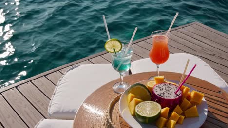 tropical cocktails and fruit platter by the ocean