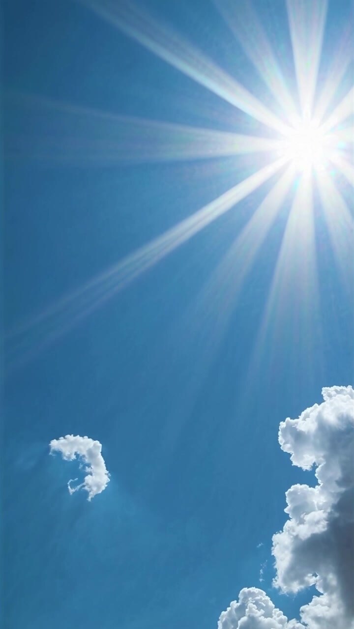 Bright Sun Shining in a Clear Blue Sky with Fluffy Clouds