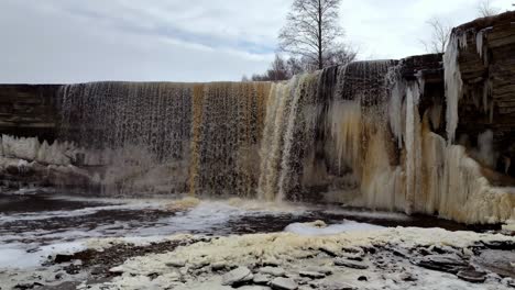 aerial-view-of-Estonia-Jägala-Waterfall-Jägala-River,-natural-forest-park-near-the-Gulf-of-Finland,-drone-nature-footage