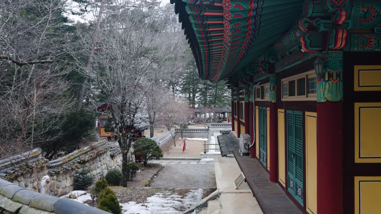 View along the colorful ornate wooden building and courtyard of Sangwonsa a traditional Korean Buddhist temple in Pyeongchang South Korea in winter