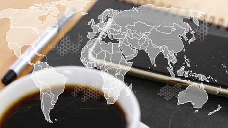 animation of world map over laptop and cup of coffee on desk