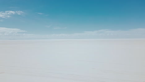 explore the surreal beauty of bolivia's salar de uyuni with stunning drone footage showcasing the vast expanse of the endless salt flats from an aerial view in daylight.