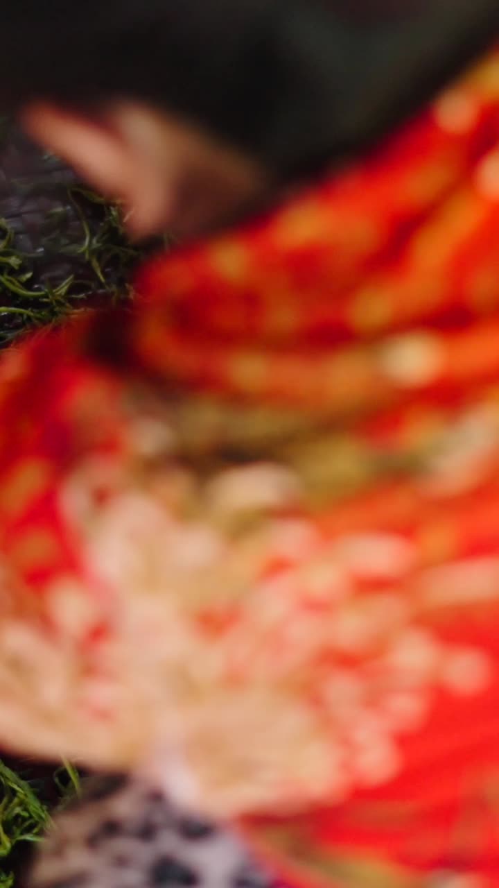 Close-up of green tea leaves being processed on a tray