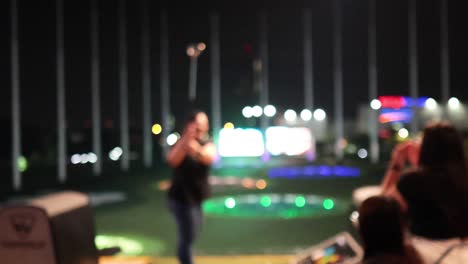 person practicing golf swing at night range