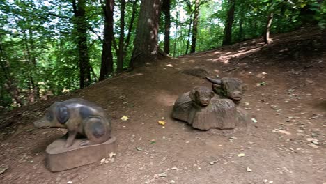 wooden sculptures of animals in a forest setting