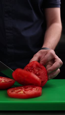 chef slicing tomatoes