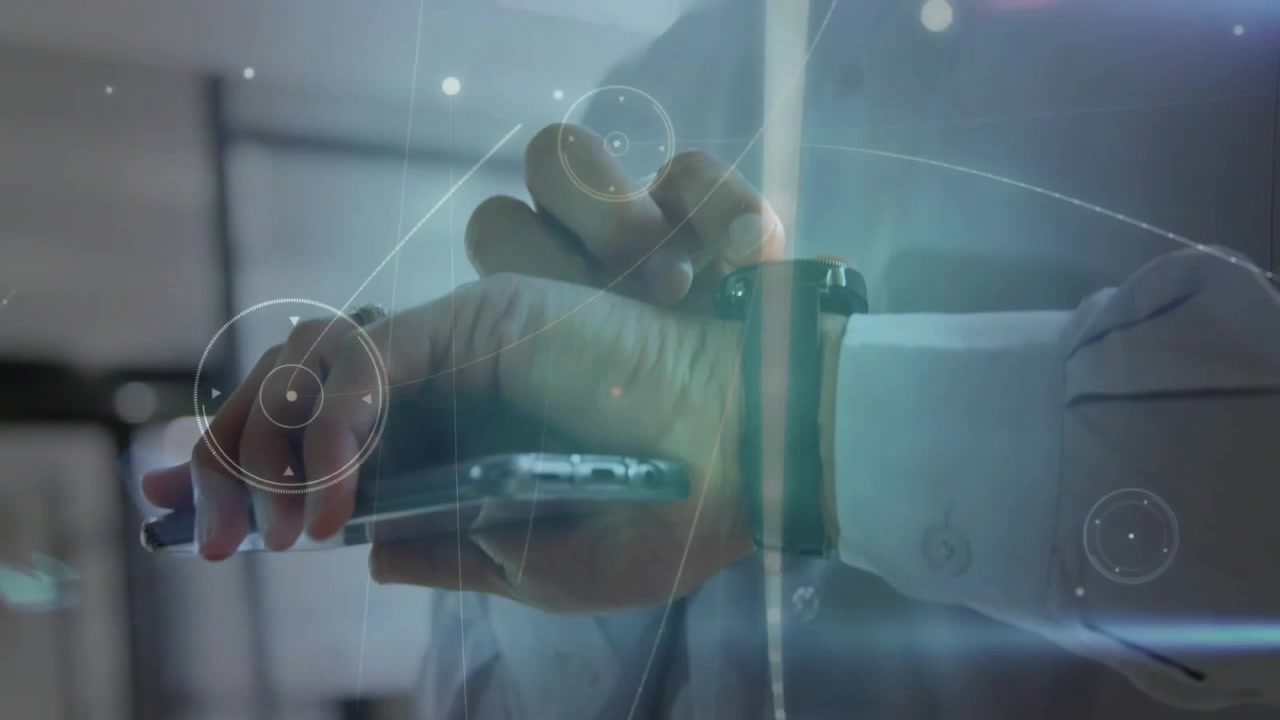 Man tapping smartwatch while holding smartphone generating animated tech graphics for data sync