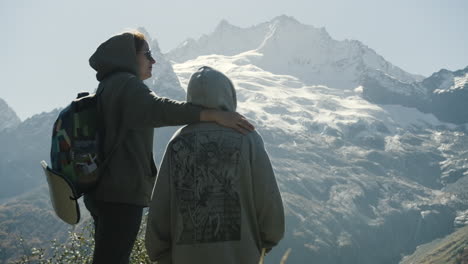 two people enjoying the view from a mountain top
