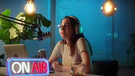 woman podcasting and broadcasting live from her home studio