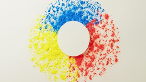 Video-of-multi-coloured-powders-and-white-circle-with-copy-space-on-white-background