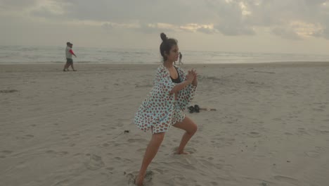 a woman finds harmony with nature as she engages in a blend of exercise and yoga at the beach