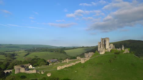 Slow-panning-shot-of-Corfe-Castle-in-early-morning-light,-Isle-of-Purbeck,-Dorset,-England