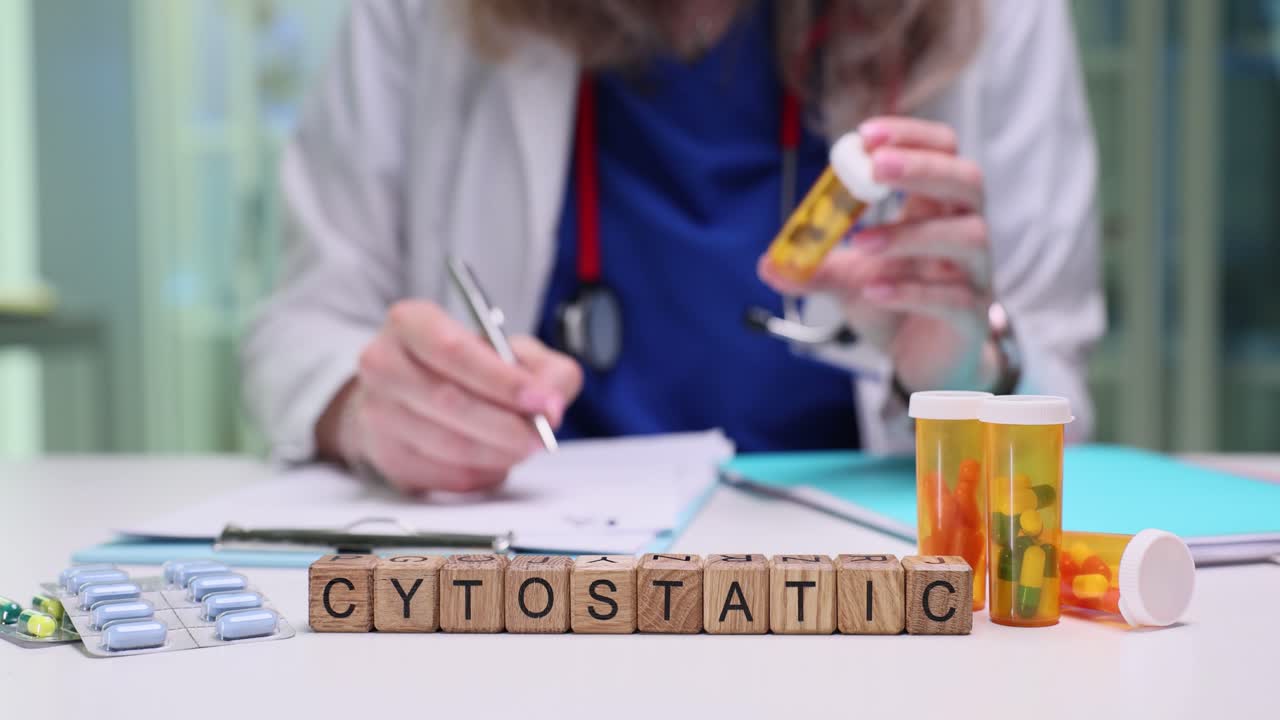 Medical professional handling cytostatic drugs on a desk