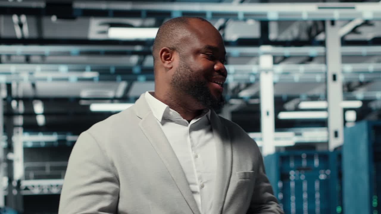 Vertical video Manager walking in high tech data center facility with rows of server racks