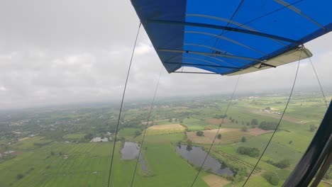 pov on ultralight aircraft to from wingside to ricefield below