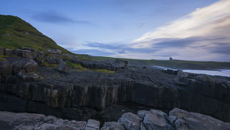 timelapse of rugged coastline cliffs with moving clouds and classiebawn castle in distance in mullaghmore head in county sligo on the wild atlantic way in ireland