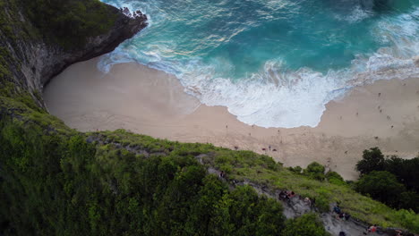 kelingking beach reveal from behind limestone cliff nusa penida indonesia
