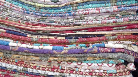 stack of colorful patterned textiles