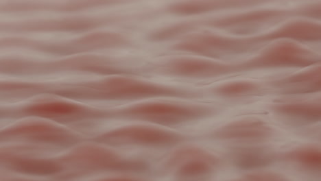 red liquid forming strange rhythmic patterns and structures