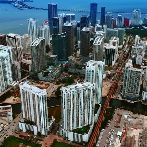 flying above the beautiful high-rise buildings in the cityscape on the waterfront of atlantic ocean. view on the miami panorama at daytime.