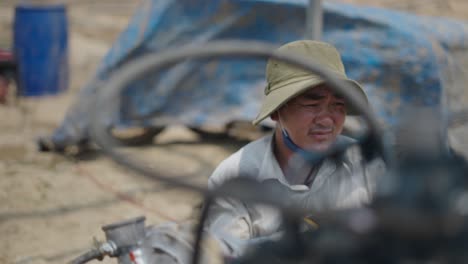 farmer working on agricultural machinery