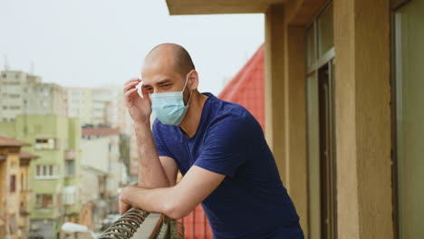 sad man on the balcony during coronavirus isolation