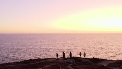 aerial: drone, people watching the sunset, steady view