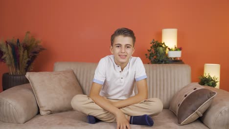 Boy-smiling-at-camera-at-home.