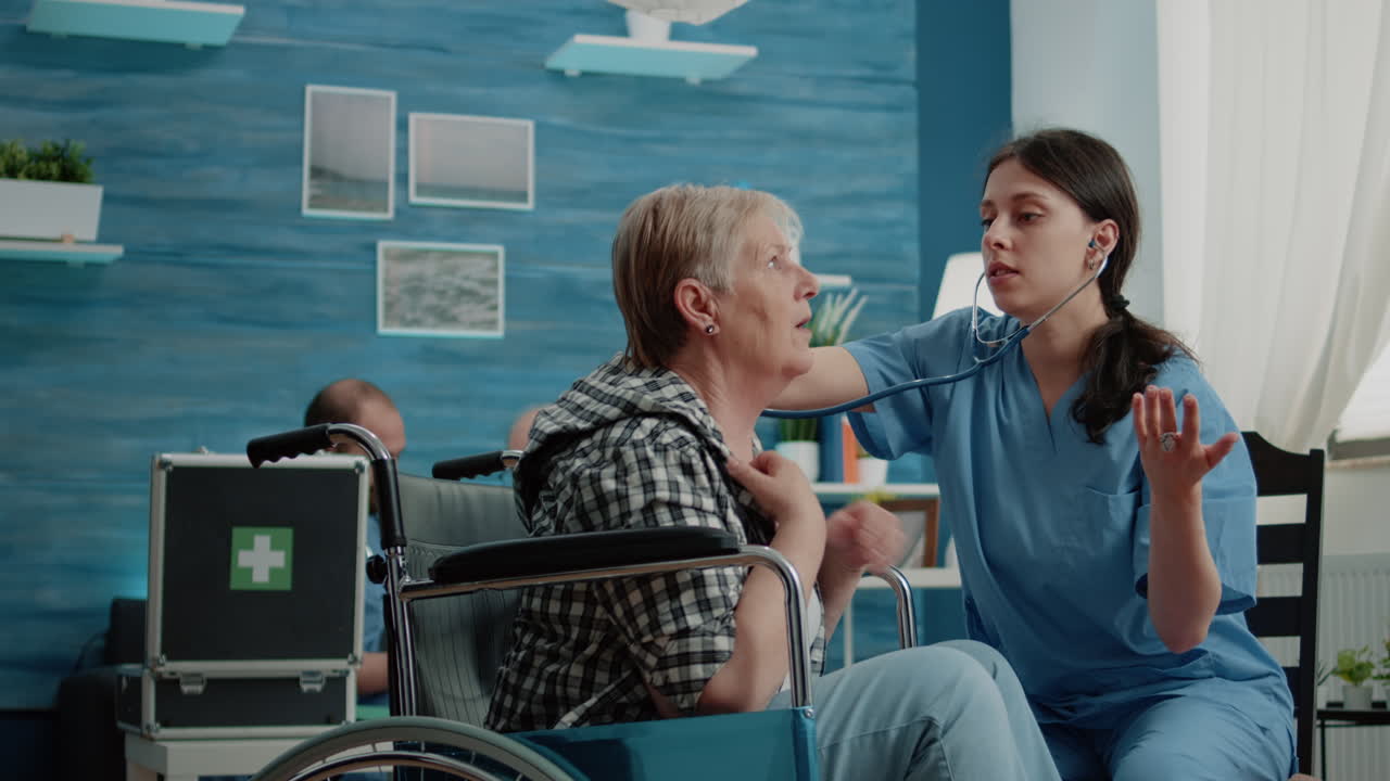 Retired woman in wheelchair receiving consultation from nurse