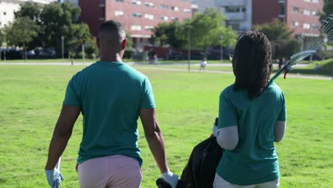 volunteers with plastic bags in park