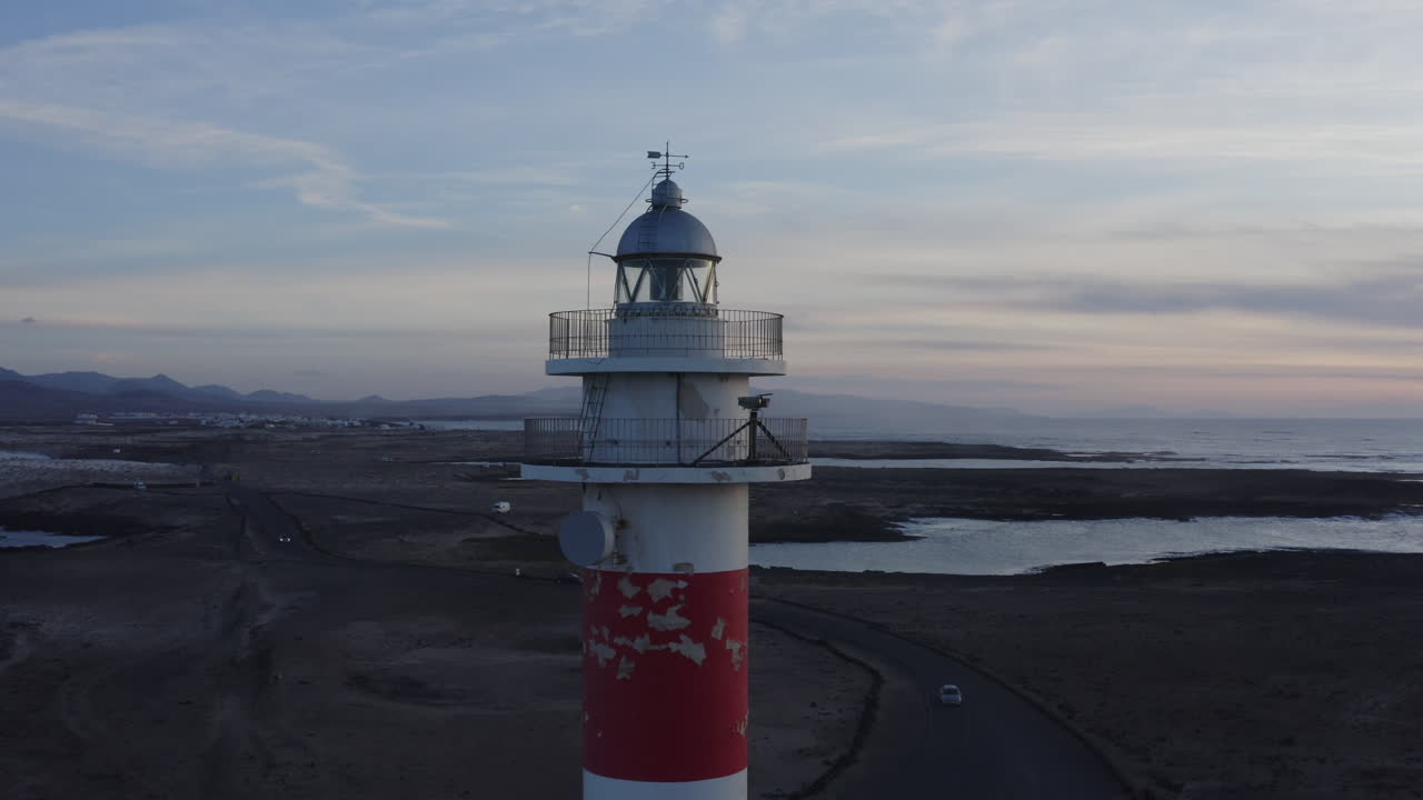 Lighthouse at Sunset over the Ocean