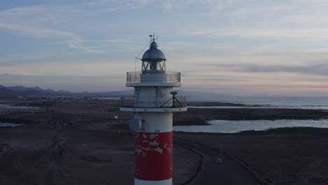 lighthouse at sunset over the ocean