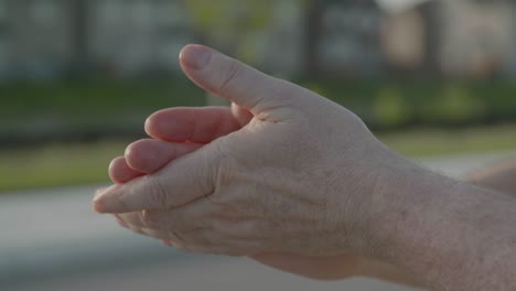 close up of rubbing sanitizer gel on hands