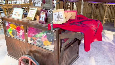 decorative cart with vibrant flowers and frames