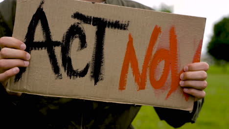 close up of a man holding a placard 1