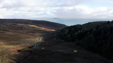 aerial - cars on a road in mull of kintyre, kintyre peninsula, scotland, wide shot