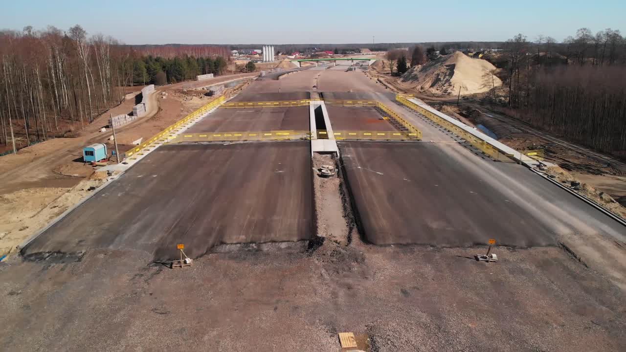 Aerial fly over the tarmac section of a new highway under construction