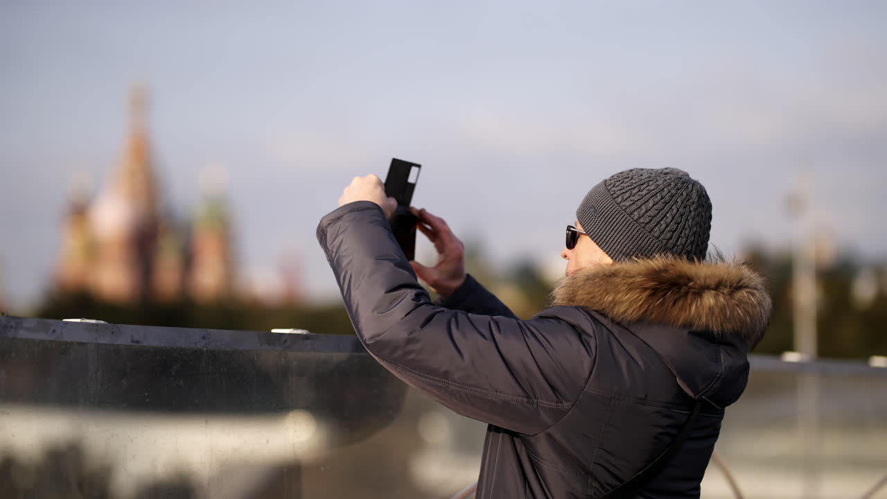 Man taking photo of Red Square in Moscow in winter