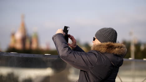 man taking photo of red square in moscow in winter