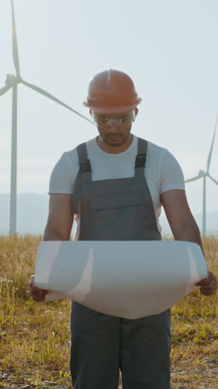 Engineer inspecting wind turbine plans