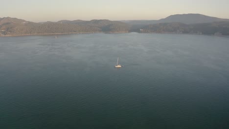 Berge-Und-Süßes-Boot-Im-Luftbild-Der-Flussdrohne-Bei-Sonnenuntergang-Im-Alentejo,-Portugal