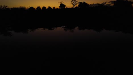 sunrise over the water towards baobab