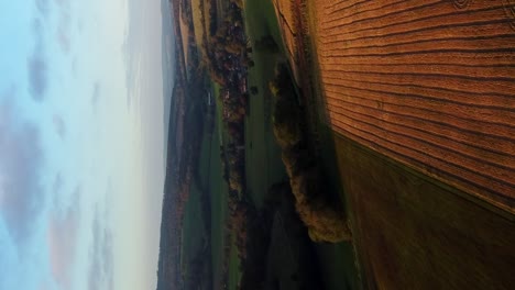 vertical cinematic establishing shot england fields and beautiful sky