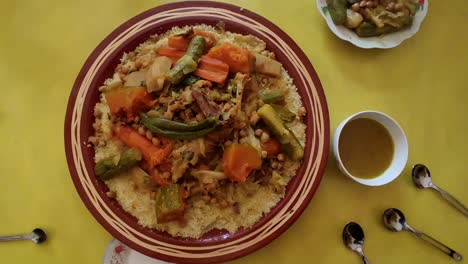 couscous meal with meat and vegetables in a traditional arabic plate ,morocco