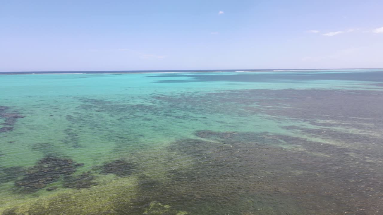 Drone aerial moving backwards over a beautiful ocean in New Caledonia