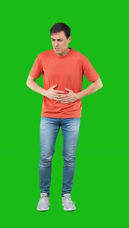 man suffering from stomach pain and nausea on green screen