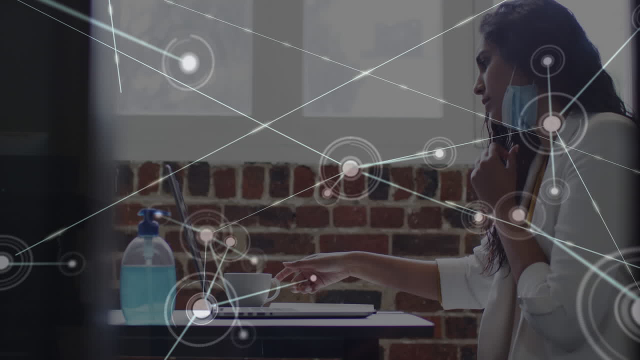 Digital composite video of network of connections against indian woman drinking coffee at office