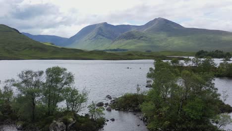 wooded islands on loch with mountains, rannoch moor, highlands, scotland, aerial