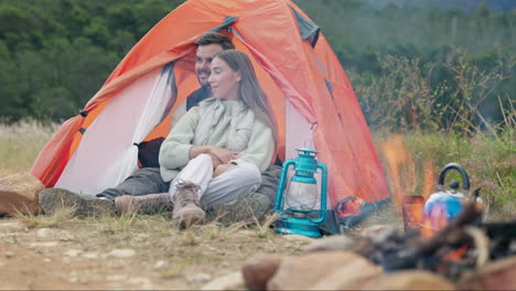 Couple,-camping-and-fire-in-tent-with-hug