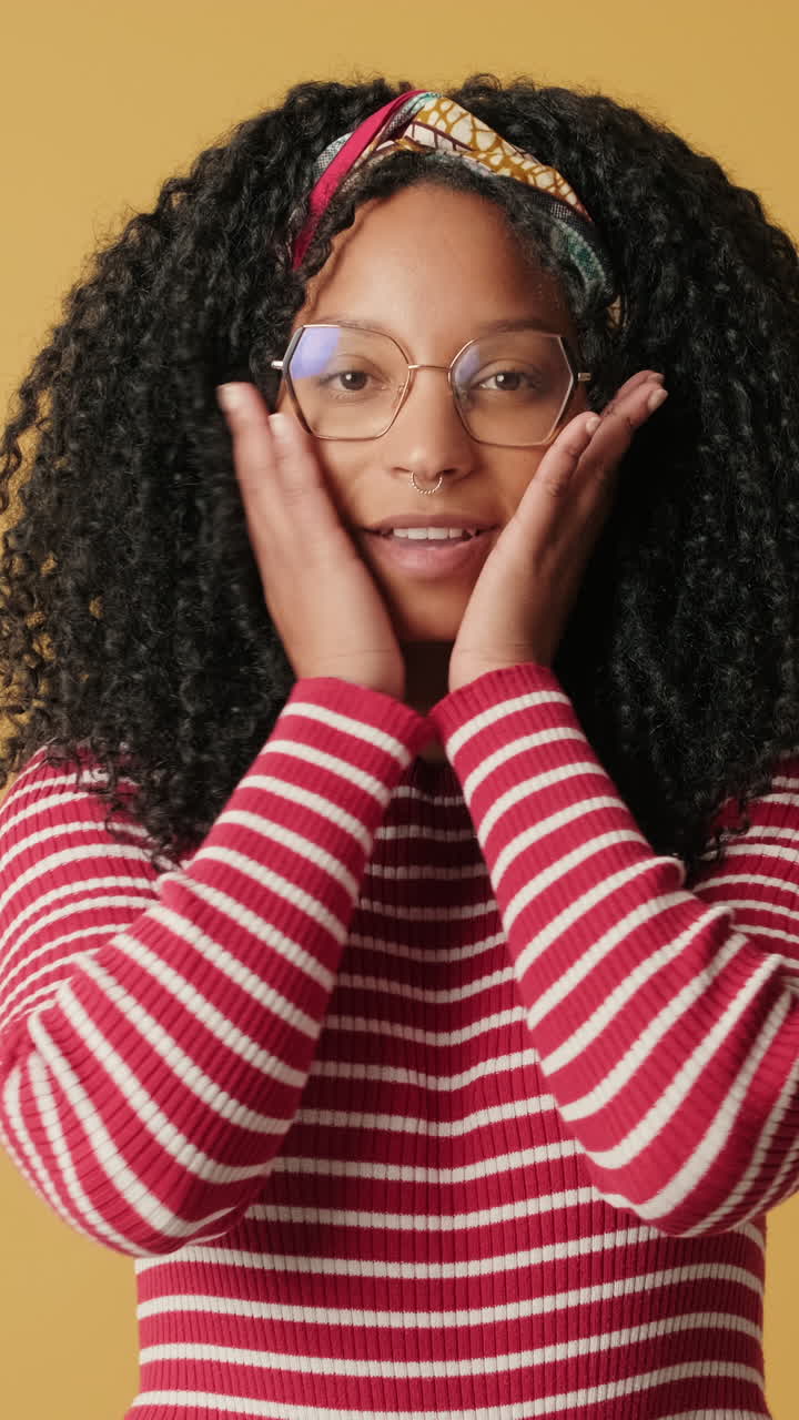 Young Woman Expressing Surprise and Happiness in Studio